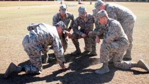cadets kneeling in a field